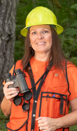 a wildlife biologist surveys for owls in the forests of Oregon